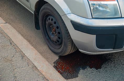 red fluid leaking from truck|Red fluid leaking from under the car. 